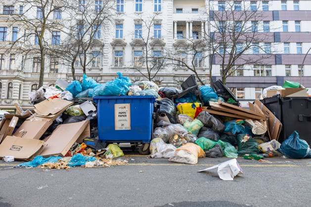 Overflowing garbage cans on Berlin streets Germany, Berlin on March 15, 2025 On Kantstrasse in Charlottenburg there are some overfilled garbage containers that have not been picked up Due to the Ver di strike, which also affects the Berlin city cleaning BSR, the garbage is not disposed of Some partly torn garbage bags lie freely on the street