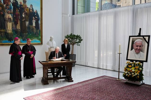 German President Frank Walter Steinmeier writes on Friday 25 April 2025 in the book of condolence for the late Pope Francis alongside Bishop Georg Baetzing Bätzing,1 v l , the Apostolic Nuncio, Archbishop Nikola EteroviÄ‡ 2 v l , and his wife, Elke Buedenbender Büdenbender , at the Apost Copyright: epd-bild ChristianxDitsch epd-Kondolenzbuch_Papst2-kopieren