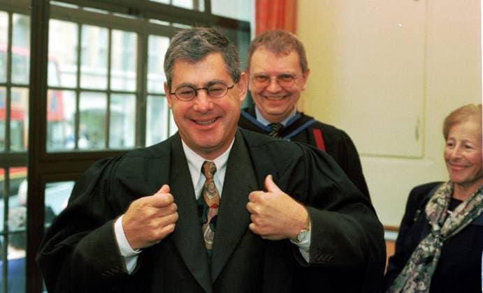 CAMERON MACKINTOSH CAMERON MACKINTOSH, OCTOBER 2000 WHO WAS AWARDED AN HONORARY FELLOWSHIP OF TRINITY COLLEGE LONDON AT THE MUSIC PRESENTATION DAY CEREMONY, BEING HELPED INTO HIS ROBES BY SIMON YOUNG THE DIRECTOR OF PERFORMANCE AT TRINITY, BEFORE THE CEREMONY. HIS MOTHER DIANA IS LOOKING ON Copyright: xJOHNxVOOSx DMGTCHPDPICT000349658237