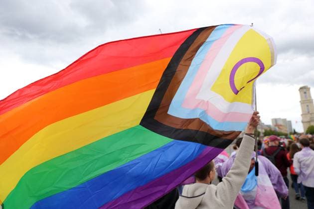 People walk with a rainbow flag in Breite Straße during a demonstration for Christopher Street Day in Potsdam, May 17, 2025 CSD in Potsdam