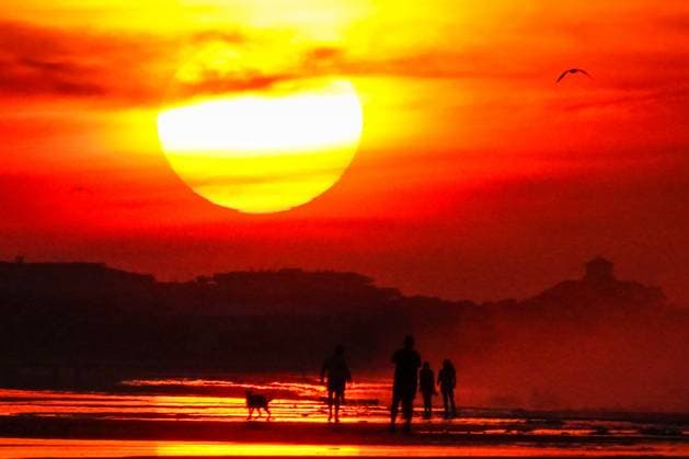 May 29, 2025, Isle Of Palms, Sc, United States: The sun rises over Front Beach on a humid, hazy morning silhouetting people walking along the coast, May 29, 2025 in Isle of Palms, South Carolina. Isle Of Palms United States - ZUMAe02_ 20250529_zaf_e02_003 Copyright: xRichardxEllisx