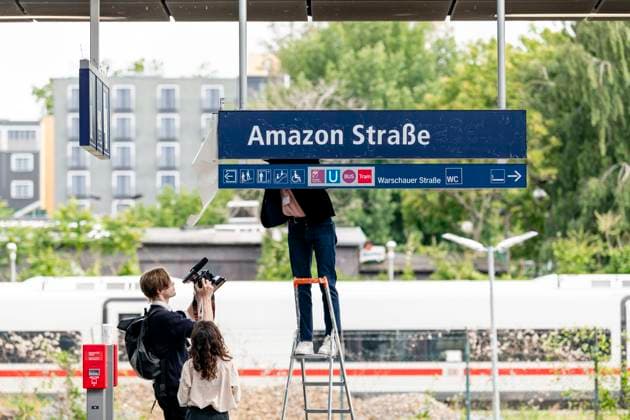 Amazon Tower Berlin action Protest art action against Amazon by Berlin artists Jakob Wirth and Marina Resende at the Warschauerstraße S-Bahn station in Berlin, directly opposite the newly opened Amazon Tower, on 16 06 2025 Copyright: xEVENTPRESSxJeremyxKnowlesx