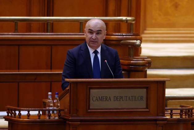 (250624) -- BUCHAREST, June 24, 2025 -- Ilie Bolojan delivers a speech during an investiture vote session at the Parliament Palace in Bucharest, Romania, June 23, 2025. Romania s new pro-European government, led by Prime Minister Ilie Bolojan, was sworn in Monday evening before President Nicusor Dan, marking the end of a period of political instability and interim leadership. The new cabinet is backed by a broad ruling coalition comprising the Social Democratic Party (PSD), National Liberal Party (PNL), Save Romania Union (USR), and the Hungarian Democratic Union of Romania (UDMR). Earlier in the day, the coalition secured a strong parliamentary mandate with 301 votes in favor and only 9 against. (Photo by Xinhua) ROMANIA-BUCHAREST-NEW