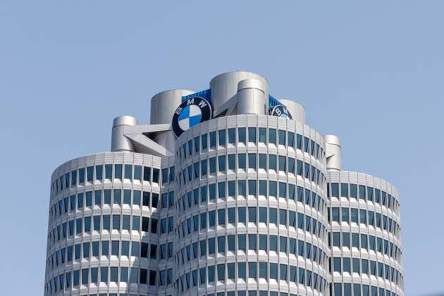 Munich, Germany 14 June 2025 Close-up of Building the BMW Head office in Munich with his unique Four-cylinder Design and the BMW Logo before a clear blue Sky 1127501002