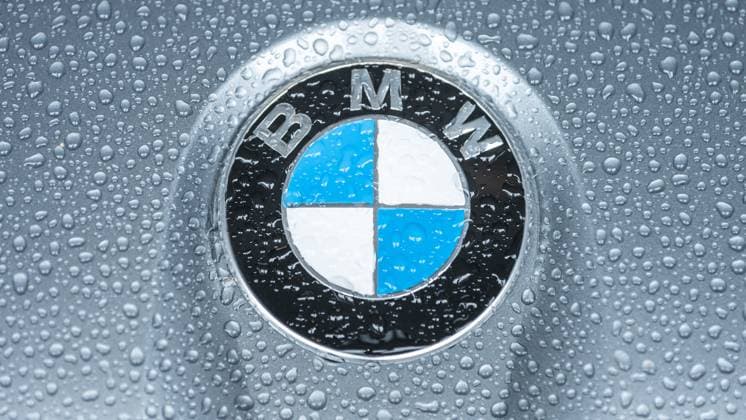 The logo of the car manufacturer BMW can be seen on a BMW M2 G87 standing in the rain Nürburg Rhineland-Palatinate Germany