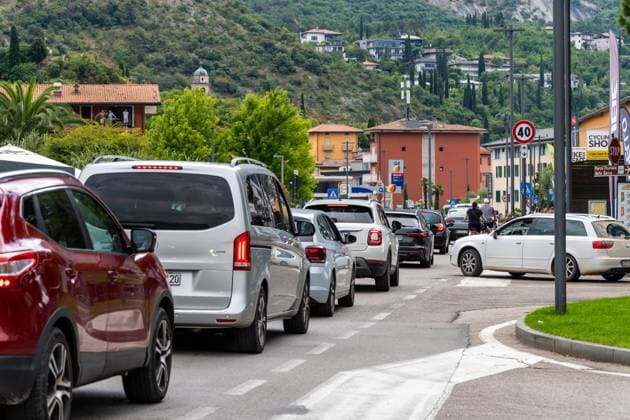 Nago-Torbole, Trentino, Italy - July 13, 2025: The heavy traffic in Torbole on Lake Garda shows the effects of tourism in summer. Long queues of cars, full streets and crowded places put a strain on infrastructure and visitors alike