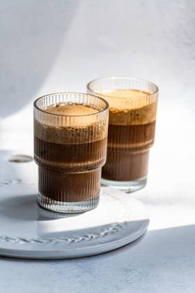 IMAGO Creative, Food, Trend, Iced Coffee Refreshing cold cappuccino in clear glass Two refreshing cold cappuccinos served in elegant clear glasses, creating a delightful blend of coffee and frothy milk. Perfect for a rejuvenating coffee break anytime Model Released AnnaBogush_ID30387_1025194_004 Copyright: xAnnaxBogushx RECORD DATE NOT STATED