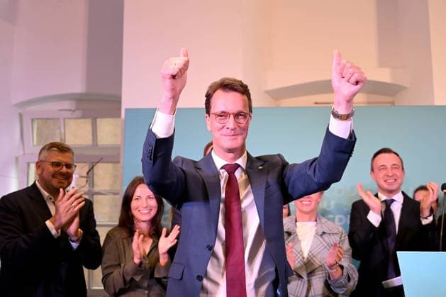 Local elections NRW Press statement CDU on 14 09 2025 in the St Lambertus community hall in Düsseldorf Minister President Hendrik Wüst CDU raises his arms after his statement and lets himself be celebrated xJFx