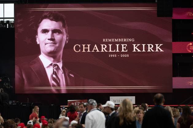 Mourners gather beneath a large screen displaying a tribute during the memorial services for Turning Point USA conservative political activist and media personality Charlie Kirk at State Farm Stadium in Glendale, Arizona, on Sunday, September 21, 2025. Kirk was assassinated at Utah Valley University while speaking at an event on campus on September 10. Police have arrested a suspect in the assassination, identified as Tyler Robinson, a 22-year-old Utah resident.  PHO20250921108 EduardoxBarraza
