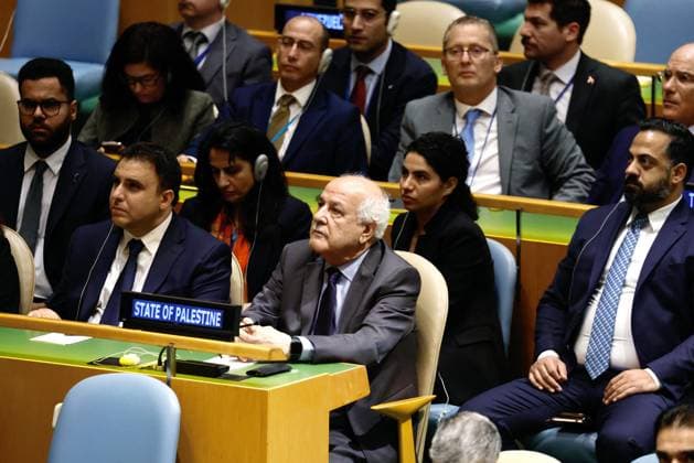 The Palestinian diplomatic delegation listens to President of the State of Palestine Mahmoud Abbas as he appears on closed circuit monitors while speaking on the third day of the 80th session of the General Debate in the UN General Assembly Hall at the United Nations Headquarters on Thursday, September 25, 2025 in New York City.  NYP202509255010 PETERxFOLEY