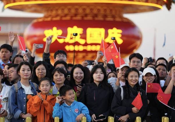 (251001) -- BEIJING, Oct. 1, 2025 -- People attend a flag-raising ceremony marking the 76th anniversary of the founding of the People s Republic of China at Tian anmen Square in Beijing, capital of China, Oct. 1, 2025. ) XINHUA PHOTOS OF THE DAY XingxGuangli