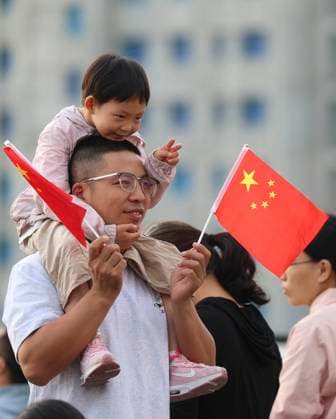(251001) -- BEIJING, Oct. 1, 2025 -- People attend a flag-raising ceremony in Shijiazhuang, north China s Hebei Province, Oct. 1, 2025. The 76th anniversary of the founding of the People s Republic of China was observed on Wednesday in various ways across the country. (Photo by Xinhua) CHINA-NATIONAL DAY-CELEBRATION (CN) LiangxZidong