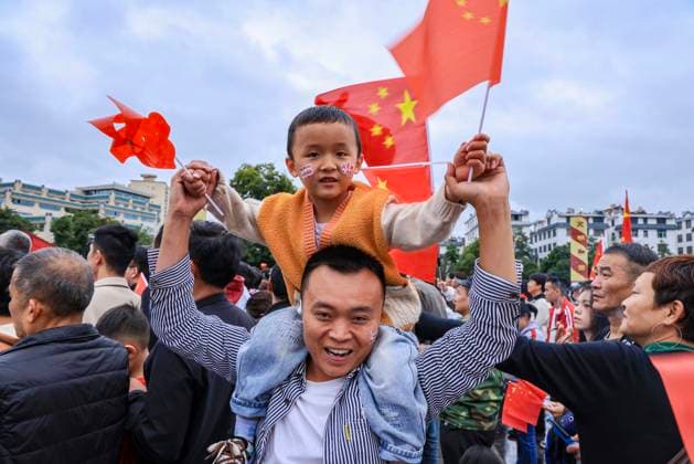 (251001) -- BEIJING, Oct. 1, 2025 -- People attend a flag-raising ceremony in Qujing City, southwest China s Yunnan Province, Oct. 1, 2025. The 76th anniversary of the founding of the People s Republic of China was observed on Wednesday in various ways across the country. (Photo by Xinhua) CHINA-NATIONAL DAY-CELEBRATION (CN) SunxWenlai