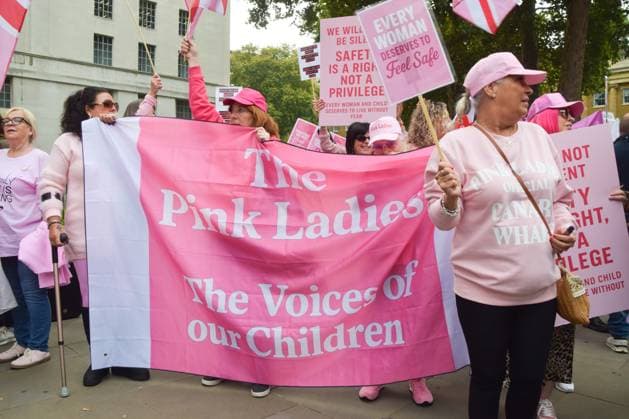 October 1, 2025, London, United Kingdom: Protesters from the group Pink Ladies hold a banner in Whitehall opposite Downing Street during a demonstration against illegal immigration and against housing migrants in hotels. The group claims that its ongoing protests are about protecting women and children. London United Kingdom - ZUMAs197 20251001_aaa_s197_090 Copyright: xVukxValcicx