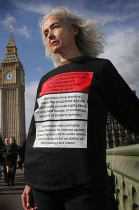 October 4, 2025, London, United Kingdom: A protester wears a t-shirt, while standing on the bridge. with the terrorism analysis, issued to the government, to guide them as to whether the group Palestine Action should be proscribed. Demonstrators risk arrest by hanging banners from Westminster Bridge. The banner drop was part of the latest Lift the Ban protest in support of the pro-Palestinian campaign group, Palestine Action. The government proscribed the group as a terrorist organization in July, after four group members broke into RAF Brize Norton and spray-painted two Voyager aircraft in June. Metropolitan Police have asked the protest organizers, Defend Our Juries (DOJ), to postpone their protest so that resources could be redirected, - ZUMAs197 20251004_aaa_s197_1276 Copyright: xMartinxPopex
