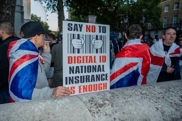October 6, 2025, London, United Kingdom: A protester holds a placard during the demonstration. A couple of hundred people gathered outside Downing Street to protest against Keir Starmer™s proposal to introduce digital ID into the UK. The demonstration was arranged by Turning Point the organisation originally set up by murdered American far-right activist Charlie Kirk. London United Kingdom - ZUMAs197 20251006_aaa_s197_220 Copyright: xLabxKyxMox