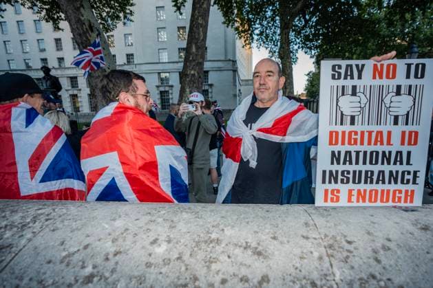 October 6, 2025, London, United Kingdom: A protester holds a placard during the demonstration. A couple of hundred people gathered outside Downing Street to protest against Keir Starmer™s proposal to introduce digital ID into the UK. The demonstration was arranged by Turning Point the organisation originally set up by murdered American far-right activist Charlie Kirk. London United Kingdom - ZUMAs197 20251006_aaa_s197_245 Copyright: xLabxKyxMox