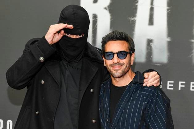 abb Haftbefehl Aykut Anhan with balaclava and Elyas M Barek as guests on the red carpet of the special screening event of the Netflix documentary highlight Babo The Haftbefehl Story at the Astor Film Lounge on 24 10 2025in Berlin Berlin Germany