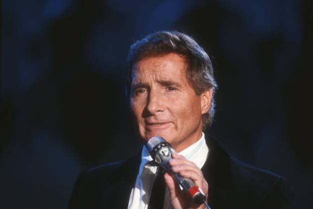Freddy Quinn singer 02 89 hear Freddy Quinn in February 1989 Austria Austrian Austrian man TV television television program pop singer actor singing pop song film musician sea shanties theater austrian singer actor cross portrait singing speaking holding microphone