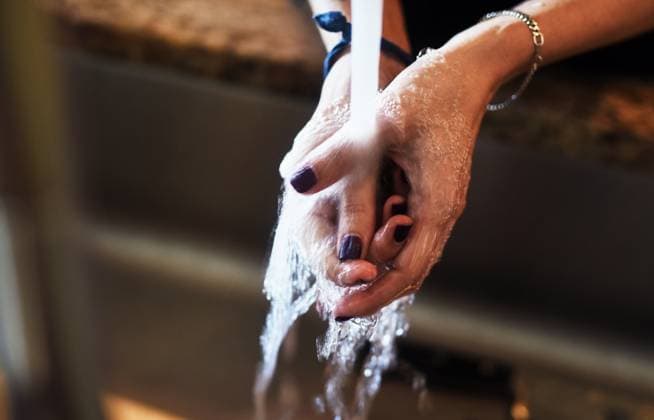 Woman, water and washing hands in home for hygiene, bacteria prevention and disinfection by sink. Healthcare, person and skin cleaning by faucet in house for germ protection, self care and wellness Woman, water and washing hands in home for hygiene, bacteria prevention and disinfection by sink. Healthcare, person and skin cleaning by faucet in house for germ protection, self care and wellness., model released, , property released, , 62889964.jpg RECORD DATE NOT STATED