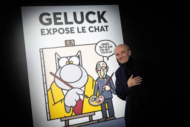 Exhibition of Philippe Geluck - Paris AJ Portrait of Philippe Geluck who pose next to a poster for the exhibition during the opening of the exhibition (vernissage) of Philippe Geluck, author of the comic book (Bande dessinee, BD, Livre) strip Le Chat at the Maillol Museum in Paris, France on November 12, 2025. Photo by Alexis Jumeau ABACAPRESS.COM Paris France  Copyright: xJumeauxAlexis ABACAx