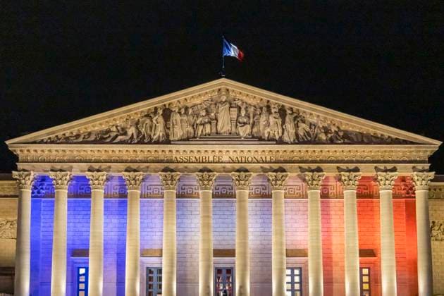 Paris, France November 13, 2025 - A flag flies atop the roof of the Palais Bourbon, seat of the National Assembly, as it is illuminated in the colours of the French flag during the commemoration of the tenth anniversary of the Paris terrorist attack. On Friday, November 13, 2015, three heavily armed Islamic State (IS) militants stormed the Bataclan concert hall in Paris during a performance by the American rock band Eagles of Death Metal, killing 90 people and taking hostages. The attack was the deadliest in a series of coordinated assaults across Paris that night, which left a total of 130 people dead. HOMMAGE ATTAQUES TERRORISTES, ILLUSTRATION, MONUMENT, ECLAIRAGE, ILLUMINATIONS, DRAPEAU FRANCAIS, TRICOLORE, ASSEMBLEE NATIONALE, PALAIS B Copyright: xVincentxIsorex