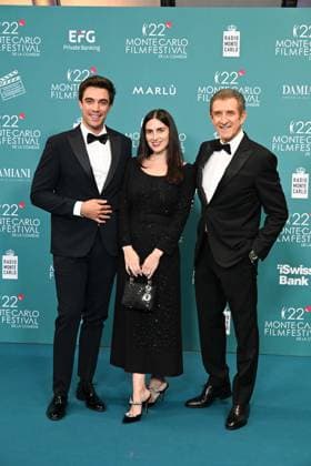 Monk, Italy: Monte Carlo, 22nd Monte Carlo Film Festival De La ComÃ die. Red carpet awards ceremony. Pictured: Ezio Greggio, Gabriele Greggio with his wife Carla. Monk Italy  - ZUMAp169 20251115_zea_p169_623 Copyright: xManuelexMangiarottix
