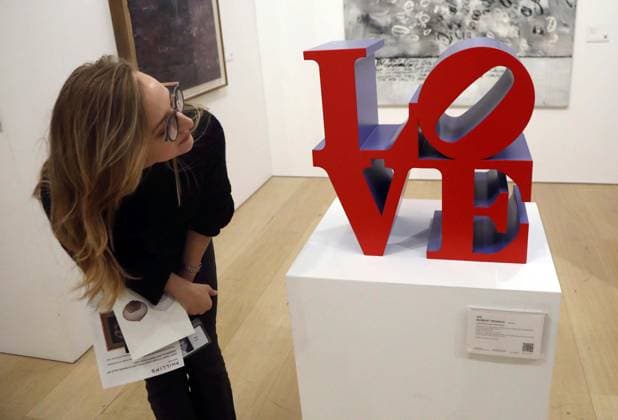 November 18, 2025, New York, New York, USA: A woman looks at Ã¢â‚¬ËœLove (Red Faces Violet Sides)Ã¢â‚¬â ¢ by artist Robert Indiana, estimate $200,000 -$300,000, seen on display at the press preview for Marquee Week Fall 2025 Modern and Comtempory Art held at Phillips Auction House New York. New York USA - ZUMAk03_ 20251118_zaf_k03_095 Copyright: xNancyxKaszermanx