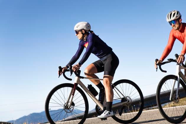 Couple cycling together on road bikes in Pyrenees mountains outdoors model released, Symbolfoto, PCLF02946