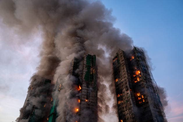 Hong Kong Building Fire Smoke and flames rise as a major fire engulfs several residential buildings at Wang Fuk Court on November 26, 2025 in Hong Kong. Serval residential building in Wang Fuk Court located in Tai Po District caught fire today, the Hong Kong Fire Department has issued the No.5 fire alarm, the fire at local time 1800 has claimed the life of one firefighter and three other people. (Photo by Vernon Yuen Nexpher Images) Hong Kong