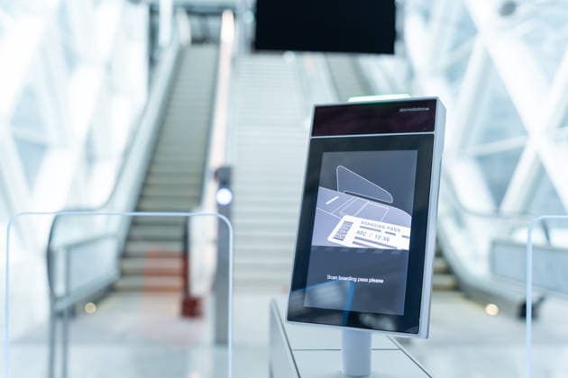 Munich, Bavaria, Germany - November 25, 2025: An automatic gate scanner at Munich Airport shows the request to scan the boarding pass