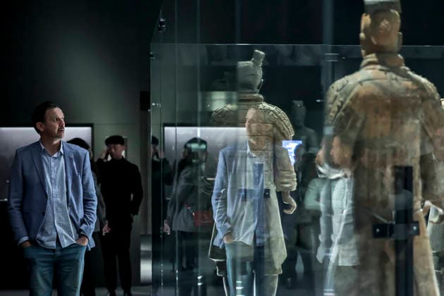 (251128) -- BUDAPEST, Nov. 28, 2025 -- A visitor views exhibits at the exhibition Civilization of the Qin and Han Dynasties - The First Chinese Emperor s Terracotta Warriors at the Museum of Fine Arts in Budapest, Hungary, Nov. 27, 2025. The Museum of Fine Arts in Budapest on Thursday opened one of the most significant Chinese cultural exhibitions ever held in Hungary, presenting more than 150 ancient artworks from the Qin and Han dynasties (221 BC-220 AD), including ten original Terracotta Warriors. Titled Civilization of the Qin and Han Dynasties - The First Chinese Emperor s Terracotta Warriors, the exhibition is jointly organized by the Museum of Fine Arts in Budapest and the Shaanxi Provincial Cultural Heritage Administration, 