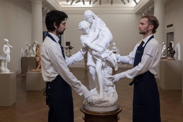 November 28, 2025, London, England, United Kingdom: Art handlers hold a sculpture titled Paul et Virginie by Charles Adrien Prosper d Epinay, estimate: 150,000 - 250,000 GBP during a photocall at Sotheby s auction house ahead of Old Master & 19th Century Paintings Sales. London United Kingdom - ZUMAs371 20251128_zip_s371_001 Copyright: xWiktorxSzymanowiczx