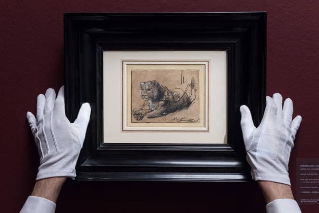 November 28, 2025, London, England, United Kingdom: An art handler holds a painting titled Young Lion Resting by Rembrandt Harmensz. Van Rijn, estimate: 15,000,000 - 20,000,000 USD during a photocall at Sotheby s auction house ahead of Old Master & 19th Century Paintings Sales. London United Kingdom - ZUMAs371 20251128_zip_s371_003 Copyright: xWiktorxSzymanowiczx