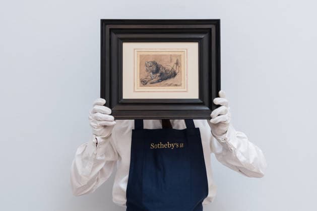 November 28, 2025, London, England, United Kingdom: An art handler holds a painting titled Young Lion Resting by Rembrandt Harmensz. Van Rijn, estimate: 15,000,000 - 20,000,000 USD during a photocall at Sotheby s auction house ahead of Old Master & 19th Century Paintings Sales. London United Kingdom - ZUMAs371 20251128_zip_s371_004 Copyright: xWiktorxSzymanowiczx