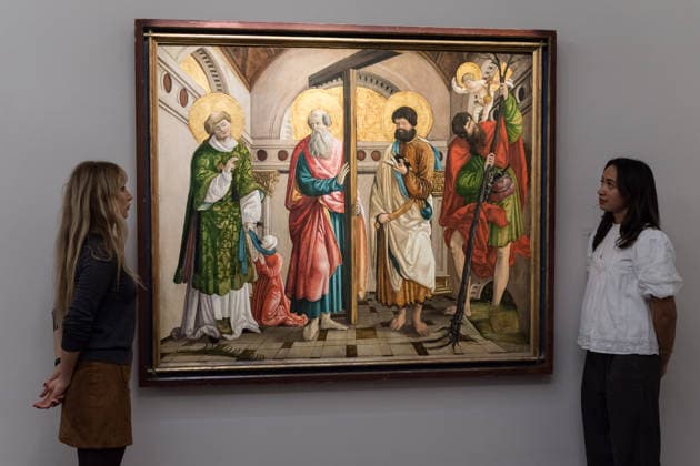 November 28, 2025, London, England, United Kingdom: Staff members look at a painting titled Saints Stephen, Andrew, Paul and Christopher, within an architectural setting by Circle of Hans Leonard SchoÂ¤ufelein, estimate: 80,000 - 120,000 GBP during a photocall at Sotheby s auction house ahead of Old Master & 19th Century Paintings Sales. London United Kingdom - ZUMAs371 20251128_zip_s371_010 Copyright: xWiktorxSzymanowiczx
