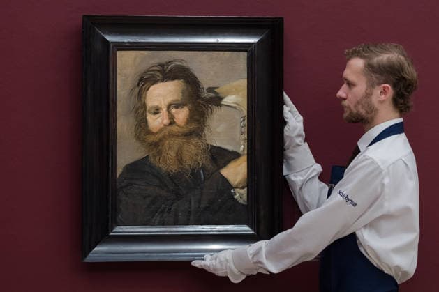 November 28, 2025, London, England, United Kingdom: An art handler holds a painting titled Portrait of Verdonck brandishing a jawbone by Frans Hals, estimate: 800,000 - 1,200,000 GBP during a photocall at Sotheby s auction house ahead of Old Master & 19th Century Paintings Sales. London United Kingdom - ZUMAs371 20251128_zip_s371_021 Copyright: xWiktorxSzymanowiczx