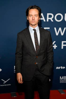 ABBberlin Tom Schilling Actor on the red carpet at the festival opening AROUND THE WORLD IN 14 FILMS at Cinestar Kino in der Kulturbrauerei Berlin on 28 11 2025 Berlin Germany