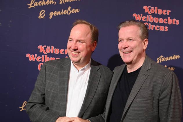 City dean Msgr Robert Kleine, dean of Cologne Cathedral and as such deputy to the cathedral provost, , l r, and funeral director and president of the Cologne Carnival Festival Committee Christoph Kuckelkorn attend the premiere of the 10th Cologne Christmas Circus