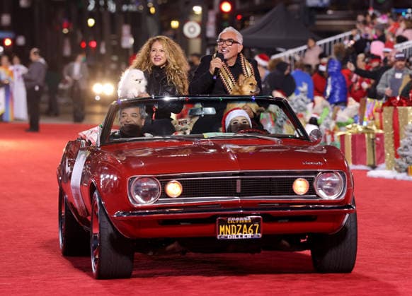 Connie Cossio and Cesar Millan cruise down Hollywood Blvd. during The 93rd Annual Hollywood Christmas Parade With Grand Marshal Luke Wilson In Support of Marine Toys for Tots in Los Angeles on Sunday, November 30, 2025.  LAP20251130767 GERGxGRUDT