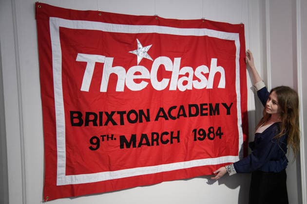 Bonhams Sound & Cinema: With Property from The Marianne Faithfull Estate Sale - Bonhams, London, UK - 1 December 2025 A staff member views Louis Theroux s First Concert - sewn cotton red banner, with The Clash Brixton Academy 9th March 1984 embroidered to centre of banner by Jeremy Deller x Louis Theroux (est. £8k - £10k) which is on auction at Bonhams Sound & Cinema: With Property from The Marianne Faithfull Estate Sale ending from 3rd December 2025 at Bonhams in London, England, UK on Monday 1 December, 2025., Credit:Justin Ng Avalon UK, England, London, Bonhams Copyright: xJustinxNgx xAvalonx 1055809929
