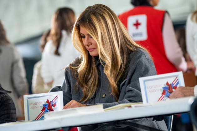 First Lady Melania Trump writes a letter for care packages for deployed Service members with during an event with Second Lady Usha Vance, the American Red Cross, U.S. Government Cabinet spouses and military spouses at Joint Base Andrews in Prince Georges County, Maryland on Monday, December 1, 2025.  WAP20251201356 BONNIExCASH