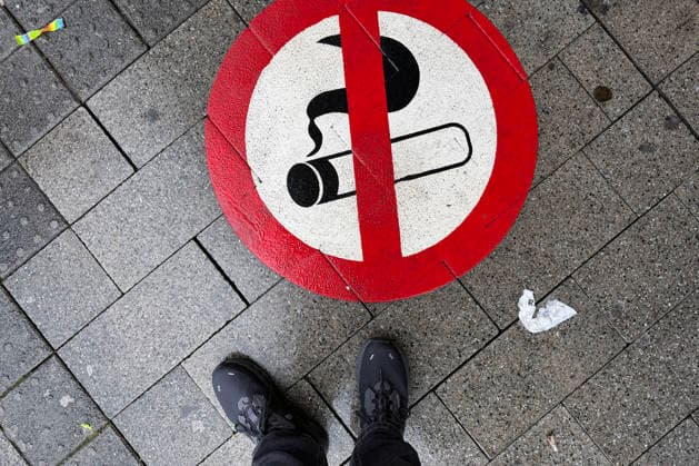 A painted, sprayed-on smoking ban sign in front of the entrance to Siegen main station Symbolic image Smoking, smoking ban on 28 11 2025 in Siegen Germany