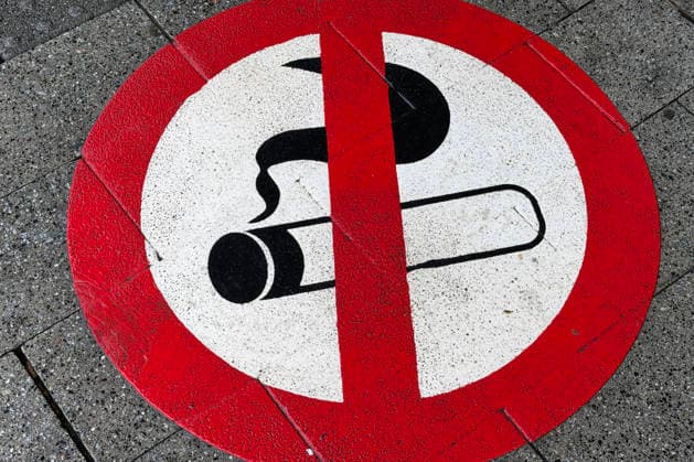 A painted, sprayed-on smoking ban sign in front of the entrance to Siegen main station Symbolic image Smoking, smoking ban on 28 11 2025 in Siegen Germany