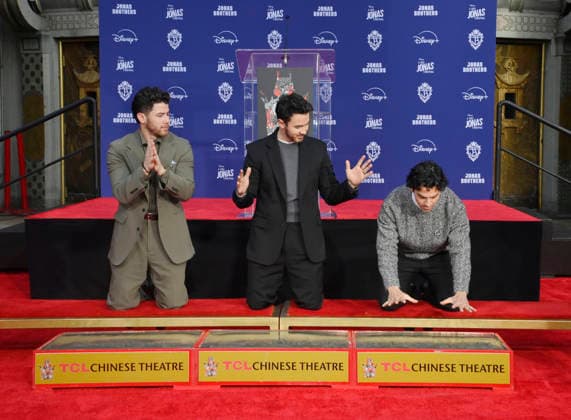 (L-R) Nick Jonas, Kevin Jonas and Joe Jonas of the Jonas Brothers participate in a hand and footprint ceremony immortalizing them in the forecourt of the TCL Chinese Theatre (formerly Grauman s) in the Hollywood section of Los Angeles on Wednesday, December 3, 2025.  LAP2025120311 JIMxRUYMEN