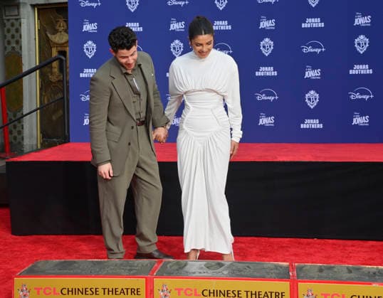 Nick Jonas is joined by his wife Priyanka Chopra at the Jonas Brothers hand and footprint ceremony immortalizing them in the forecourt of the TCL Chinese Theatre (formerly Grauman s) in the Hollywood section of Los Angeles on Wednesday, December 3, 2025.  LAP2025120319 JIMxRUYMEN