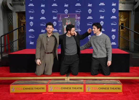 (L-R) Nick Jonas, Kevin Jonas and Joe Jonas of the Jonas Brothers participate in a hand and footprint ceremony immortalizing them in the forecourt of the TCL Chinese Theatre (formerly Grauman s) in the Hollywood section of Los Angeles on Wednesday, December 3, 2025.  LAP2025120307 JIMxRUYMEN