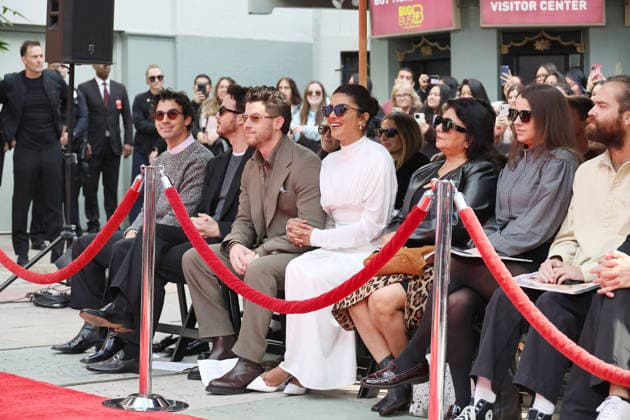 December 3, 2025, Los Angeles, California, USA: Joe Jonas, Kevin Jonas, Nick Jonas, Priyanka Chopra Jonas, Dr Madhu Chopra at a ceremony honoring the Jonas Brothers with hand and foot prints at the TCL Chinese Theatre IMAX. Los Angeles USA - ZUMAg107 20251203_zep_g107_003 Copyright: xNinaxPrommerx
