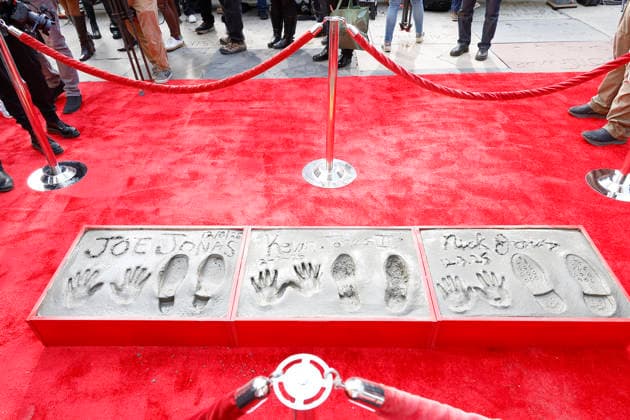 December 3, 2025, Los Angeles, California, USA: Jonas Brothers prints at a ceremony honoring the Jonas Brothers with hand and foot prints at the TCL Chinese Theatre IMAX. Los Angeles USA - ZUMAg107 20251203_zep_g107_005 Copyright: xNinaxPrommerx
