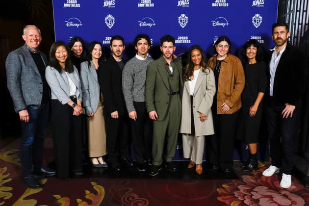 December 3, 2025, Los Angeles, California, USA: Kevin Jonas, Joe Jonas, Nick Jonas, Disney executives at a ceremony honoring the Jonas Brothers with hand and foot prints at the TCL Chinese Theatre IMAX. Los Angeles USA - ZUMAg107 20251203_zep_g107_012 Copyright: xNinaxPrommerx